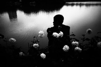A calm scene of a woman meditating by a tranquil lake.