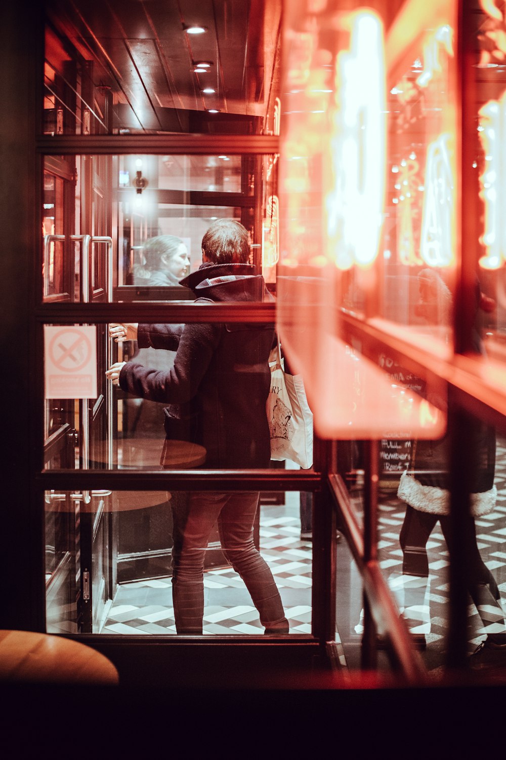 man standing near glass wall