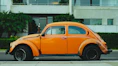 shallow focus photography of orange Volkswagen Beetle