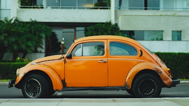 shallow focus photography of orange Volkswagen Beetle