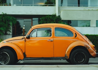 shallow focus photography of orange Volkswagen Beetle