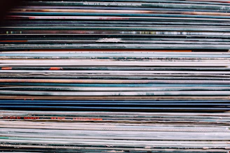 Close-up of a colorful stack of music CDs with vibrant album covers