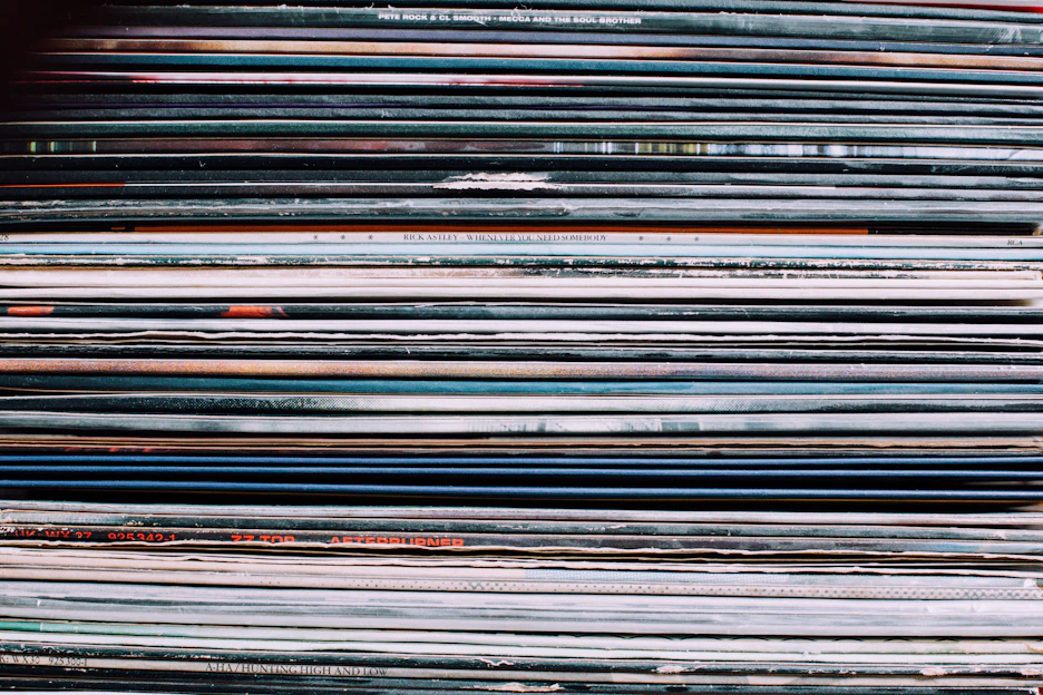 Close-up of a colorful stack of music CDs with vibrant album covers