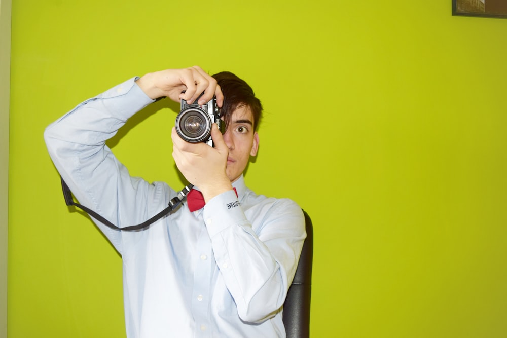 man holding DSLR camera