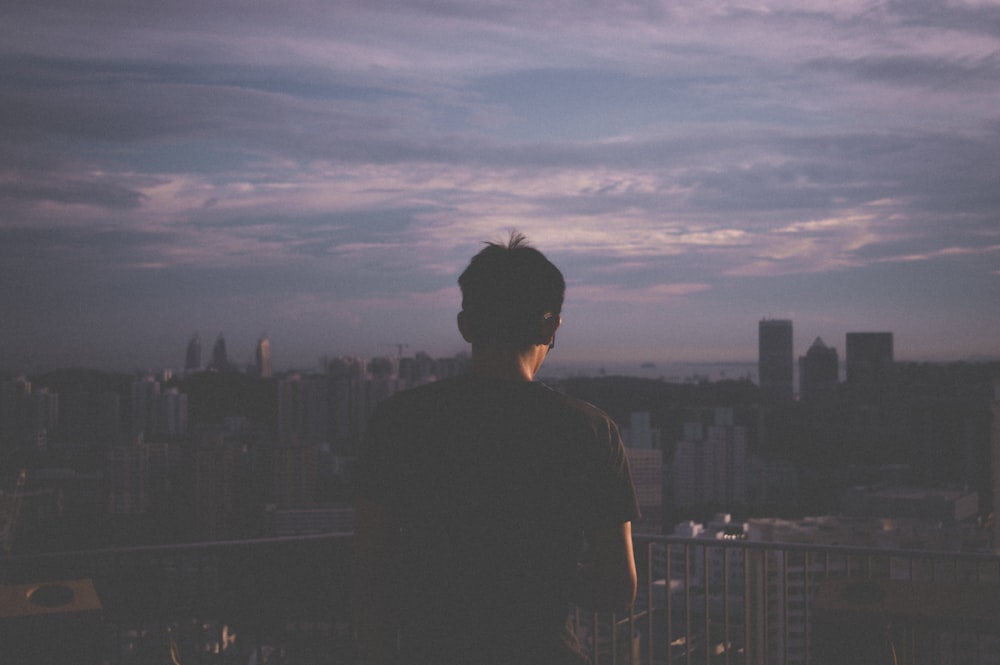 a man standing on top of a tall building