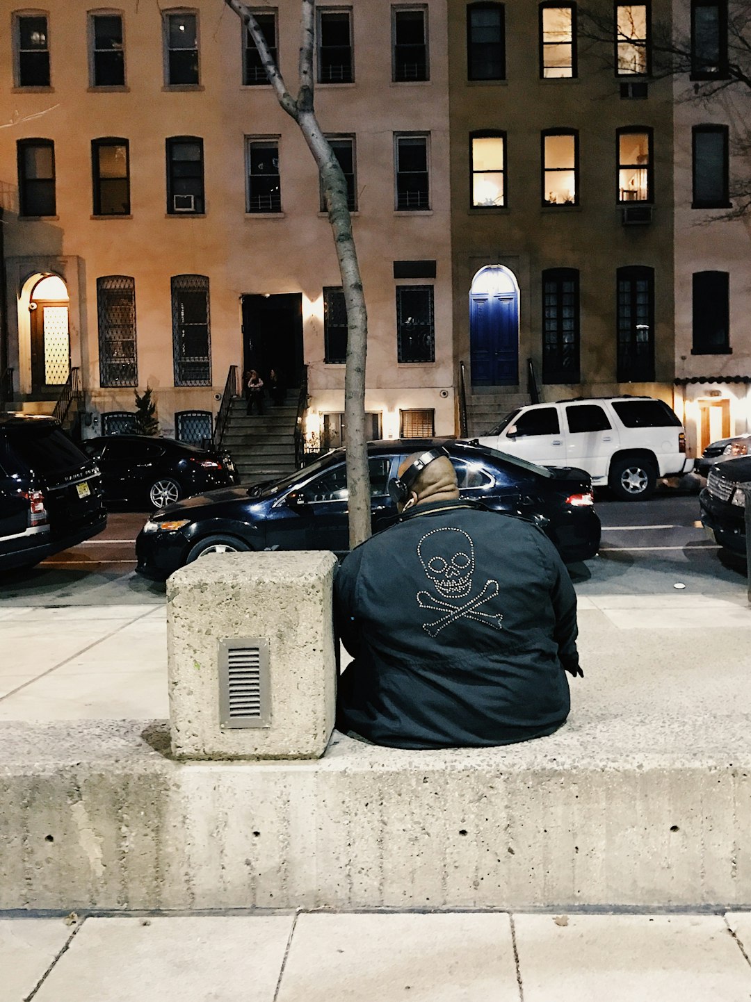 man sitting on bench beside tree