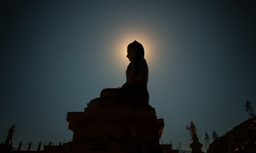 silhouette photo of Buddha statue