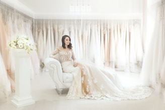 woman sitting on white leather armchair inside house