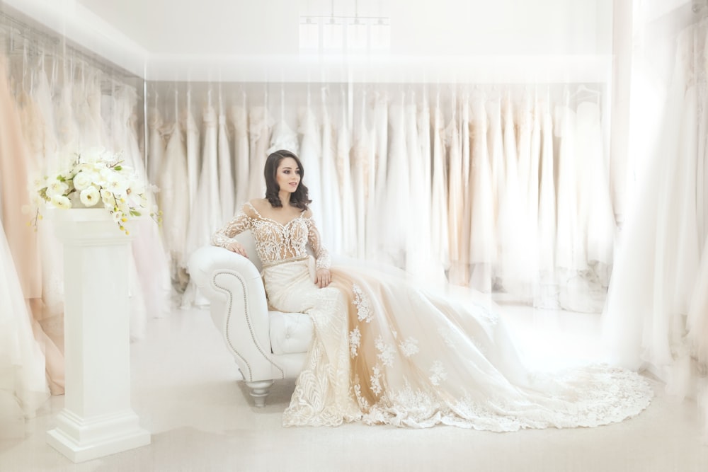 woman sitting on white leather armchair inside house