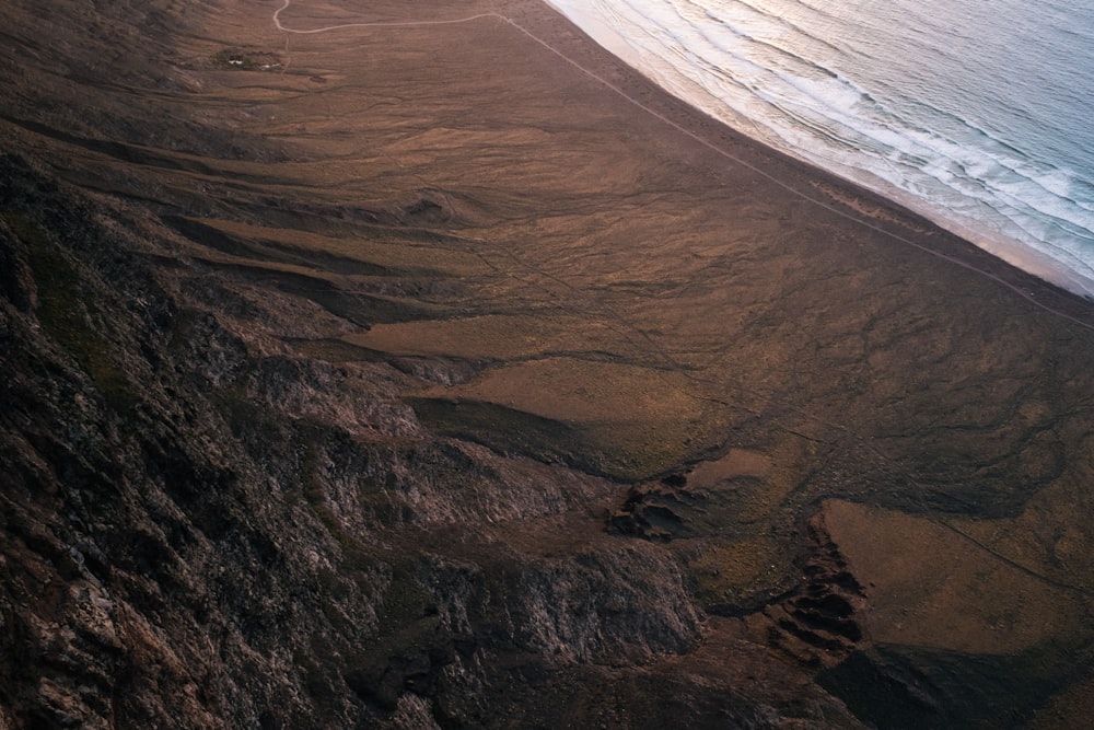 aerial view photography of body of water and brown sand