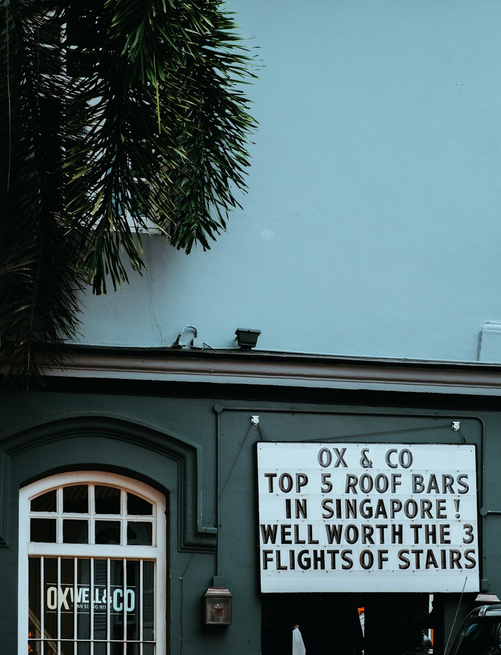 grey house with signage board