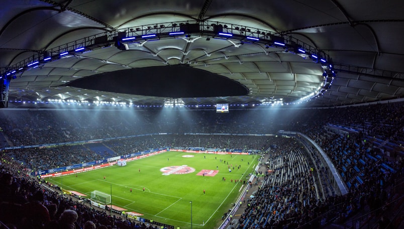 Bustling soccer stadium illuminated during a night game with spectators, capturing the essence 