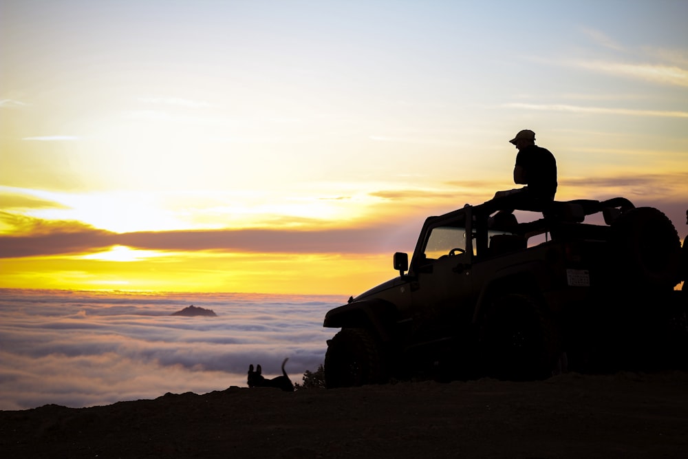 silhouette photography of person sitting on truck