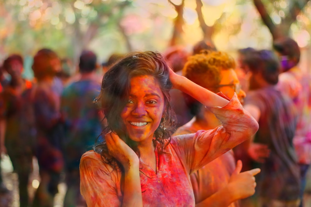 smiling woman holding her head and hair during daytime