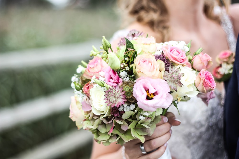 woman holding bouquet of flowers