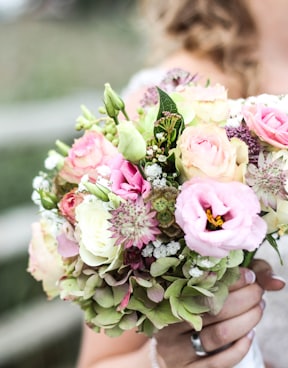 woman holding bouquet of flowers