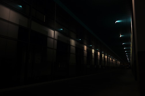 Warm corridor lighting guiding through a contemporary office space.