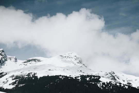 snow-covered mountain under cloudy sky during daytime in Jungfraujoch Switzerland