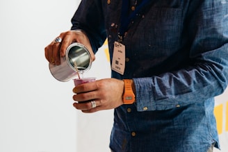 person holding gray cup