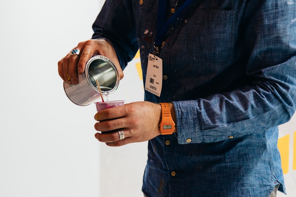 person holding gray cup