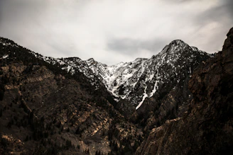 cloudy sky above snow covered mountain