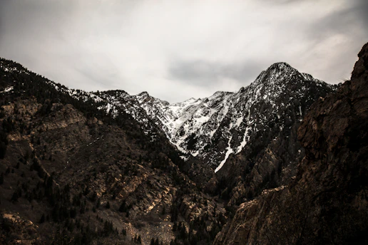cloudy sky above snow covered mountain