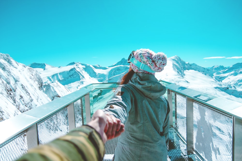 femme tournée vers l’arrière près des montagnes