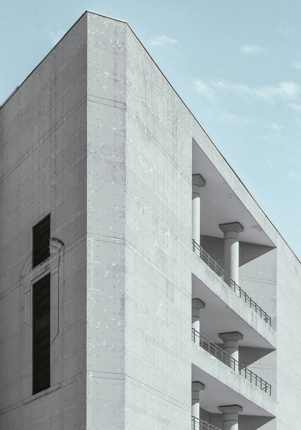 white concrete high rise building under cloudy sky