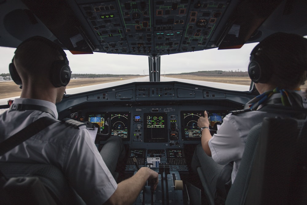 two men driving plane at daytime
