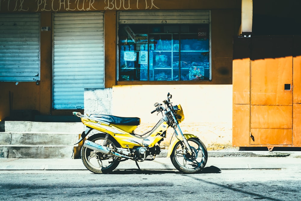 yellow motorcycle parked outside store