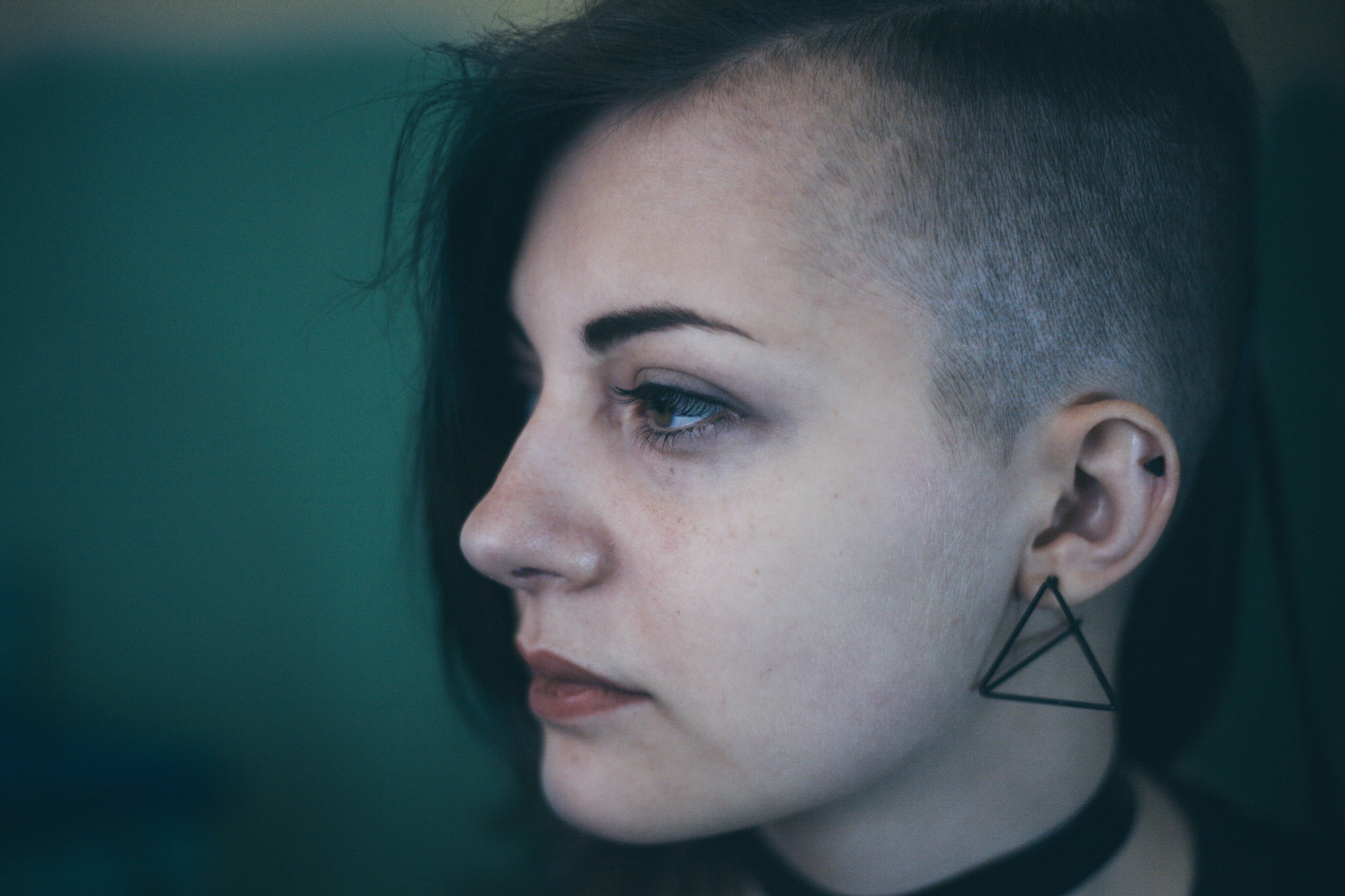 Woman With An Edgy Shaved Haircut Looks Sad And Defeated