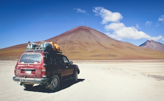 A rugged 4x4 vehicle equipped with Ironman 4x4 Mongolia products driving through the vast Mongolian steppe under a dramatic sky.