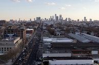 An aerial view of a bustling cityscape with moving trucks on the road.