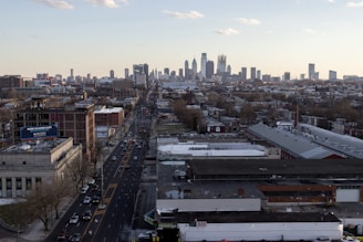 Aerial view of a bustling city with vehicles on the road.