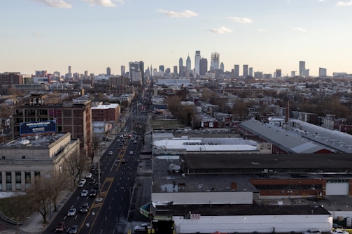 An aerial view of a bustling city with cars on the road.