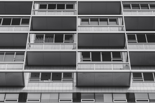 Screenshot of a property management site with bold sans-serif headings and spacious asymmetric grid design.