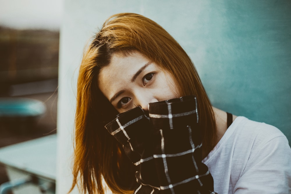 woman hiding her mouth with her hands