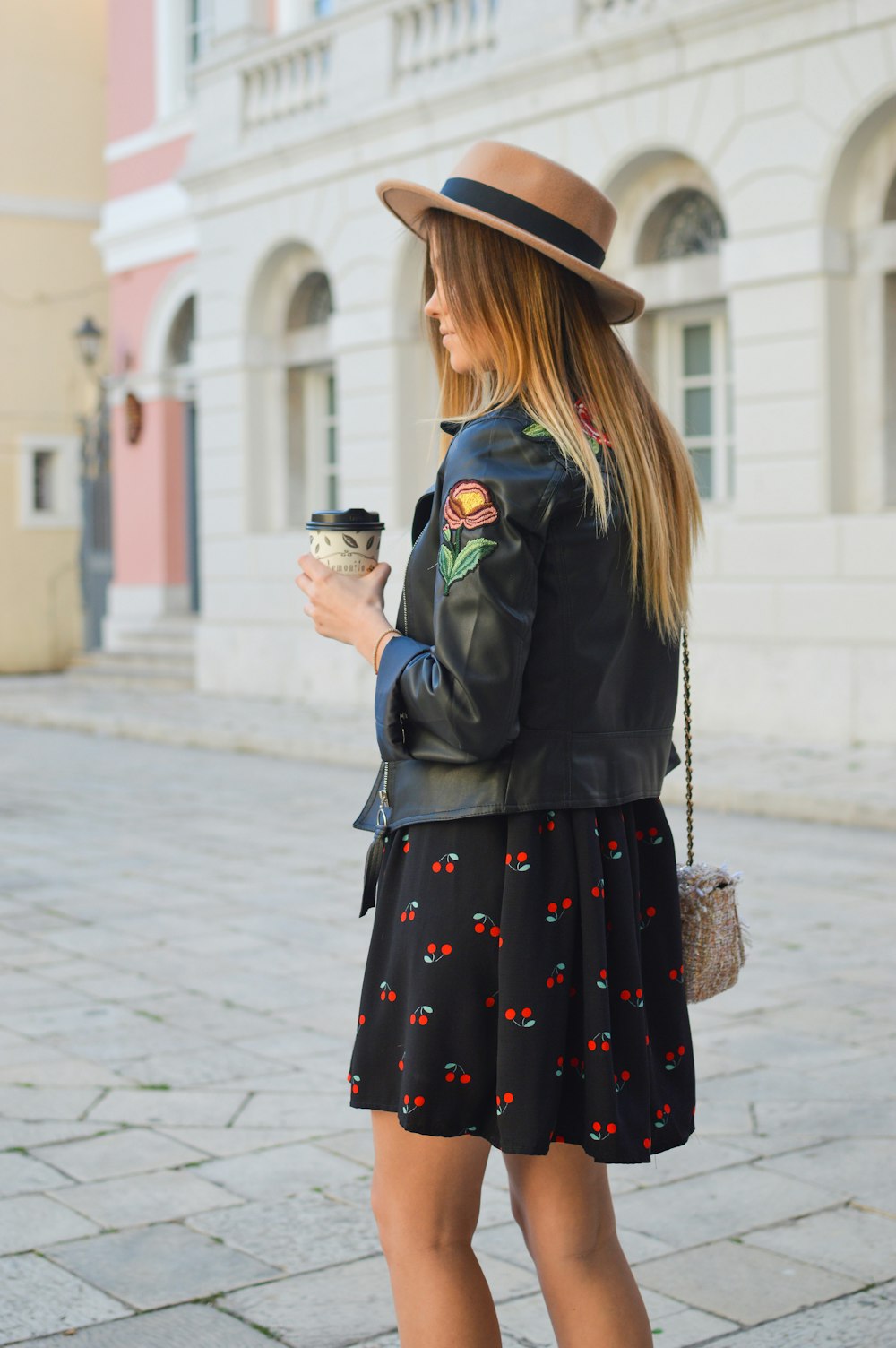 woman holding disposable cup