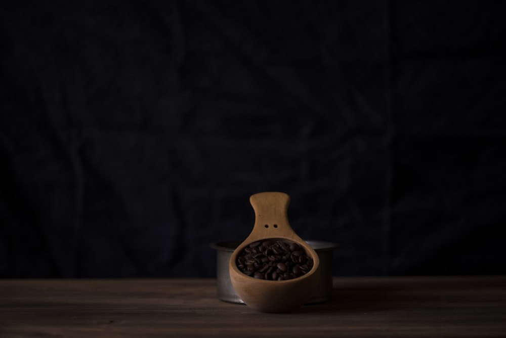 beige wooden scoop beside gray stainless steel container