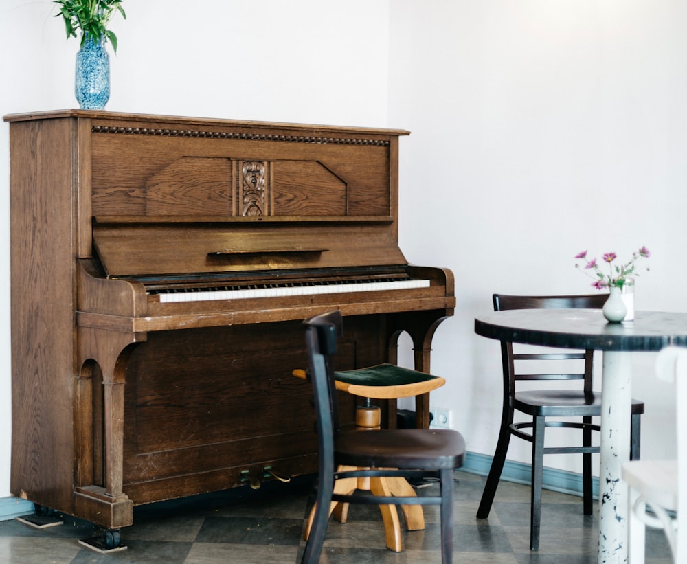 brown piano in front of white wall