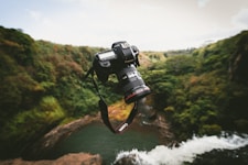 thrown black Canon DSLR camera