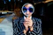 person using magnifying glass enlarging the appearance of his nose and sunglasses
