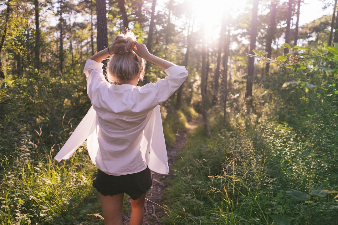 woman standing on the forest at daytime