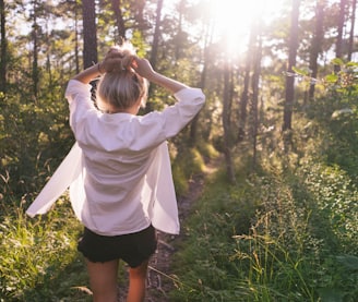 woman standing on the forest at daytime