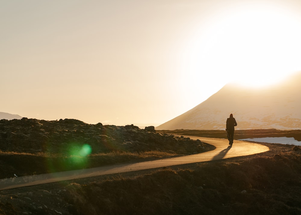 silhouette photography person on curve-road