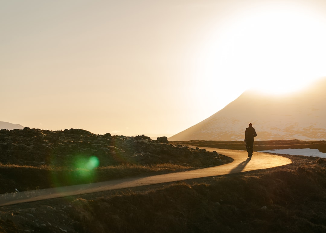silhouette photography person on curve-road, It was at the end of the day… we were heading to godafoss…that walk was lig