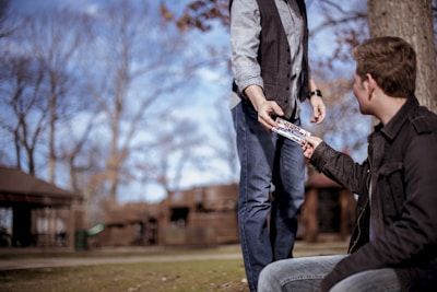 person giving something to man
