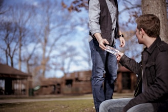 person giving something to man