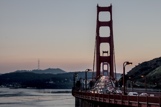 vehicle on bridge during daytime in Golden Gate Bridge United States