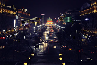 A bustling cityscape of Santo Domingo at night with illuminated buildings and traffic.